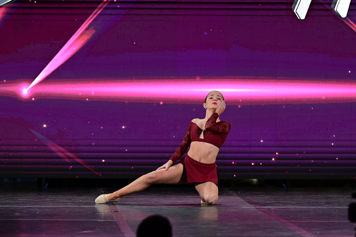 Dancer in red two piece outfit on stage