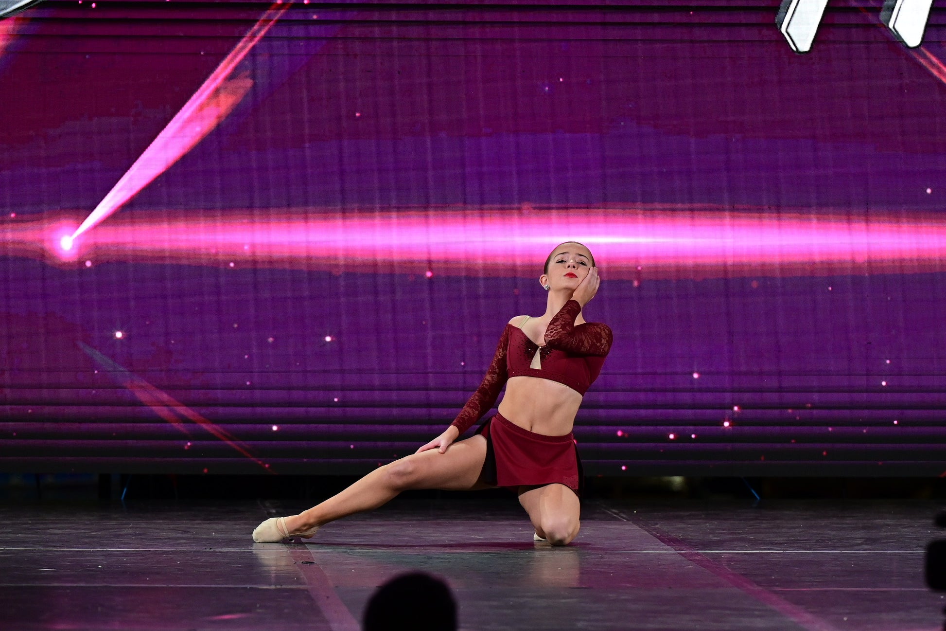 Dancer in red two piece outfit on stage